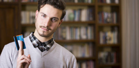 young man holding credit card