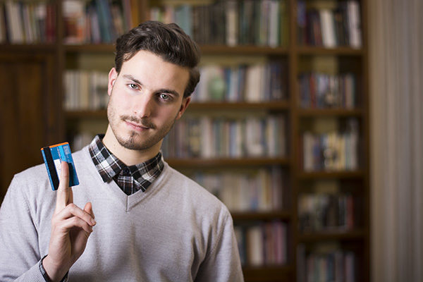 young man holding credit card