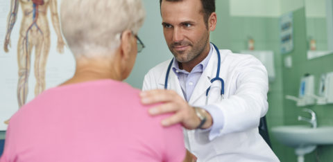 elderly female patient at the doctor's office discussing medical debt consolidation