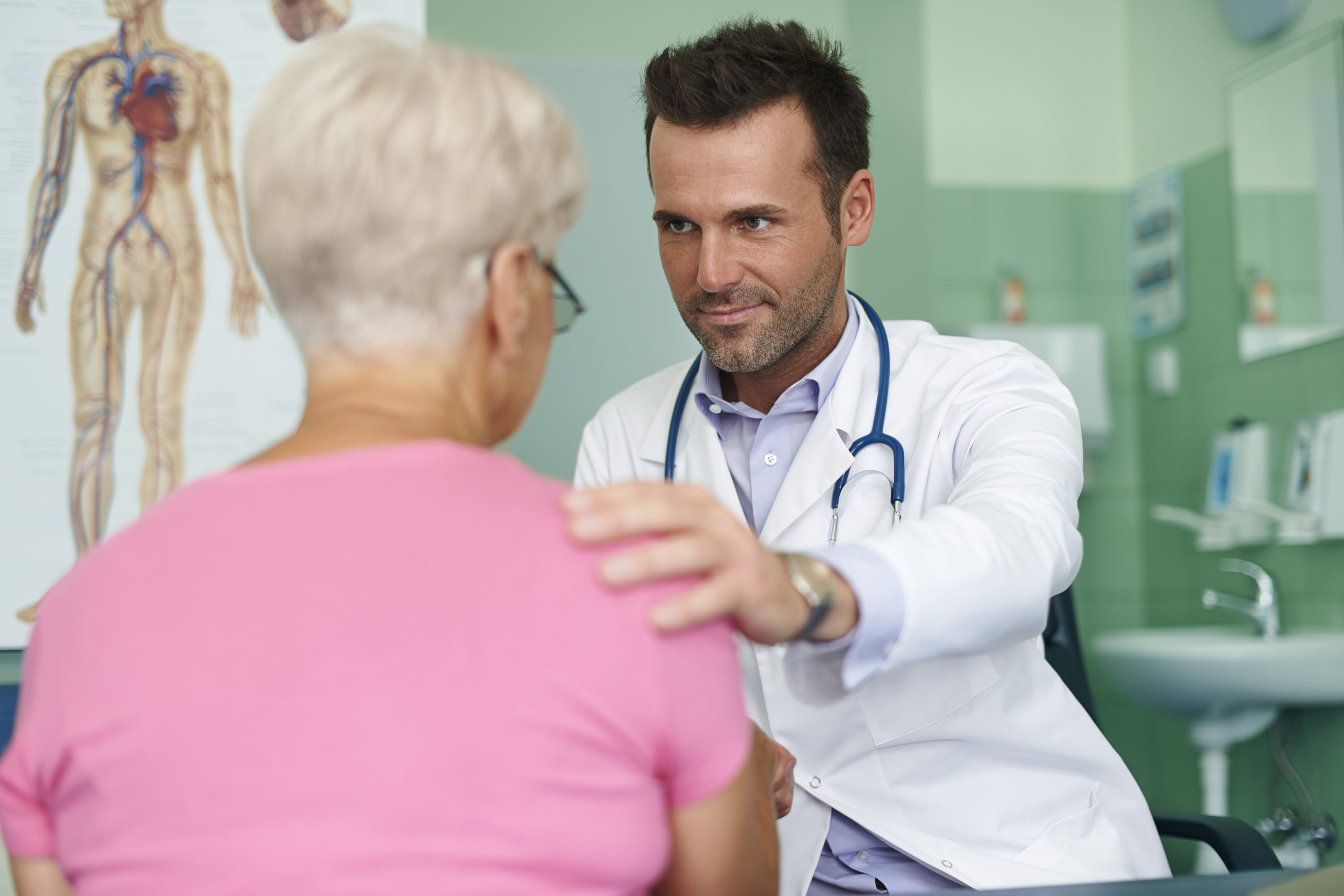 elderly female patient at the doctor's office discussing medical debt consolidation