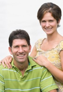 Man and woman facing camera enjoying debt relief