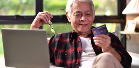 senior man researching the cost of a credit card