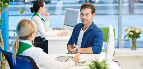 Young man listening to bank manager