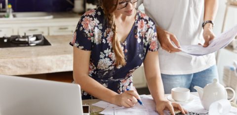 couple figuring out steps to better debt management scaled