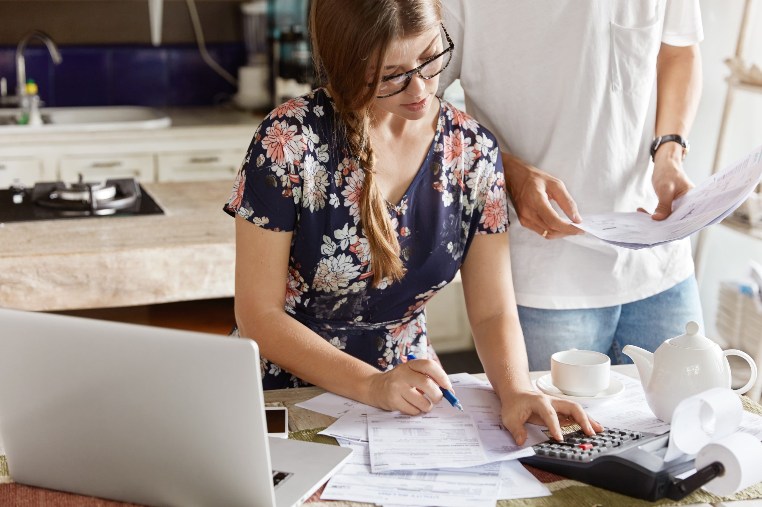 couple figuring out steps to better debt management scaled