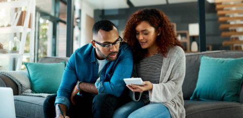 a young couple discussing credit card debt management