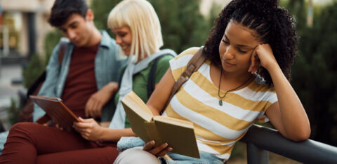 young woman reading a money management book