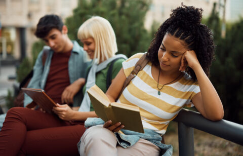 young woman reading a money management book