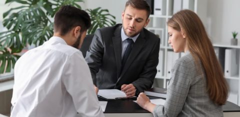 couple speaking with a lawyer