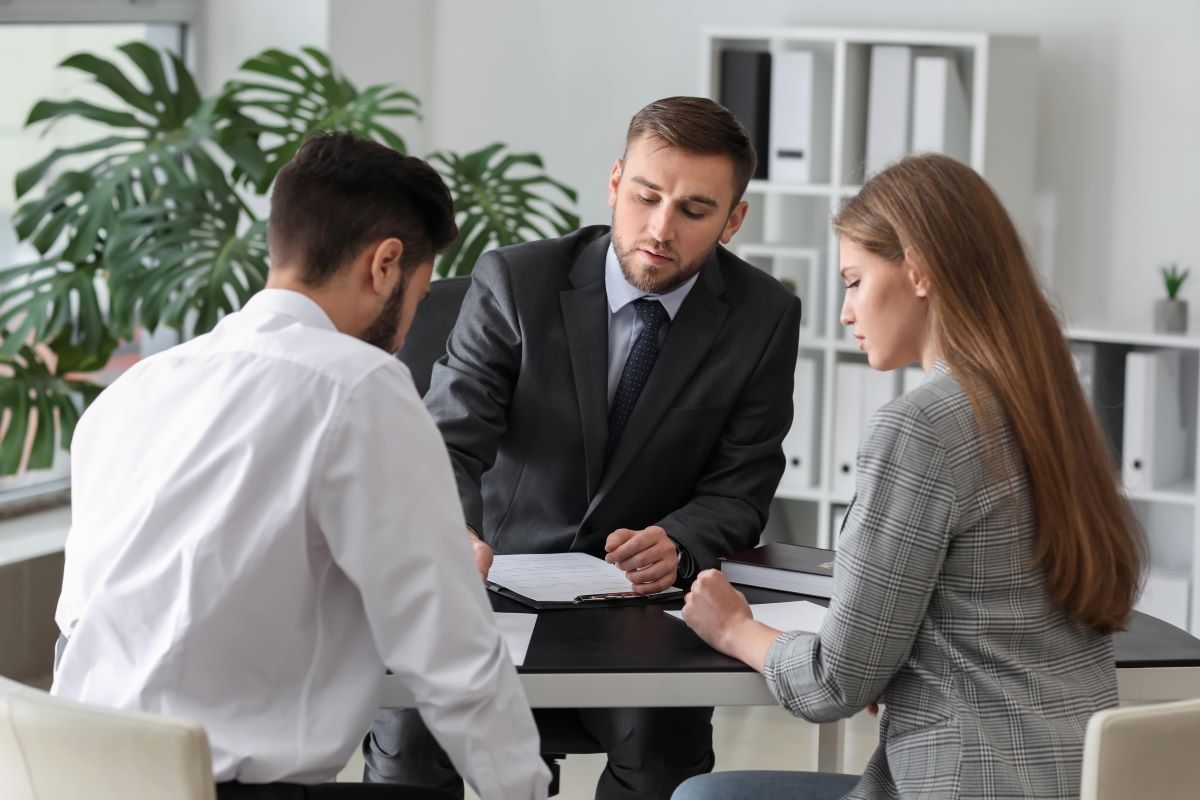 couple speaking with a lawyer