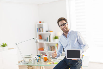 Man holding computer working at home