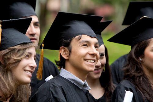 Young adults grduating with caps and gowns