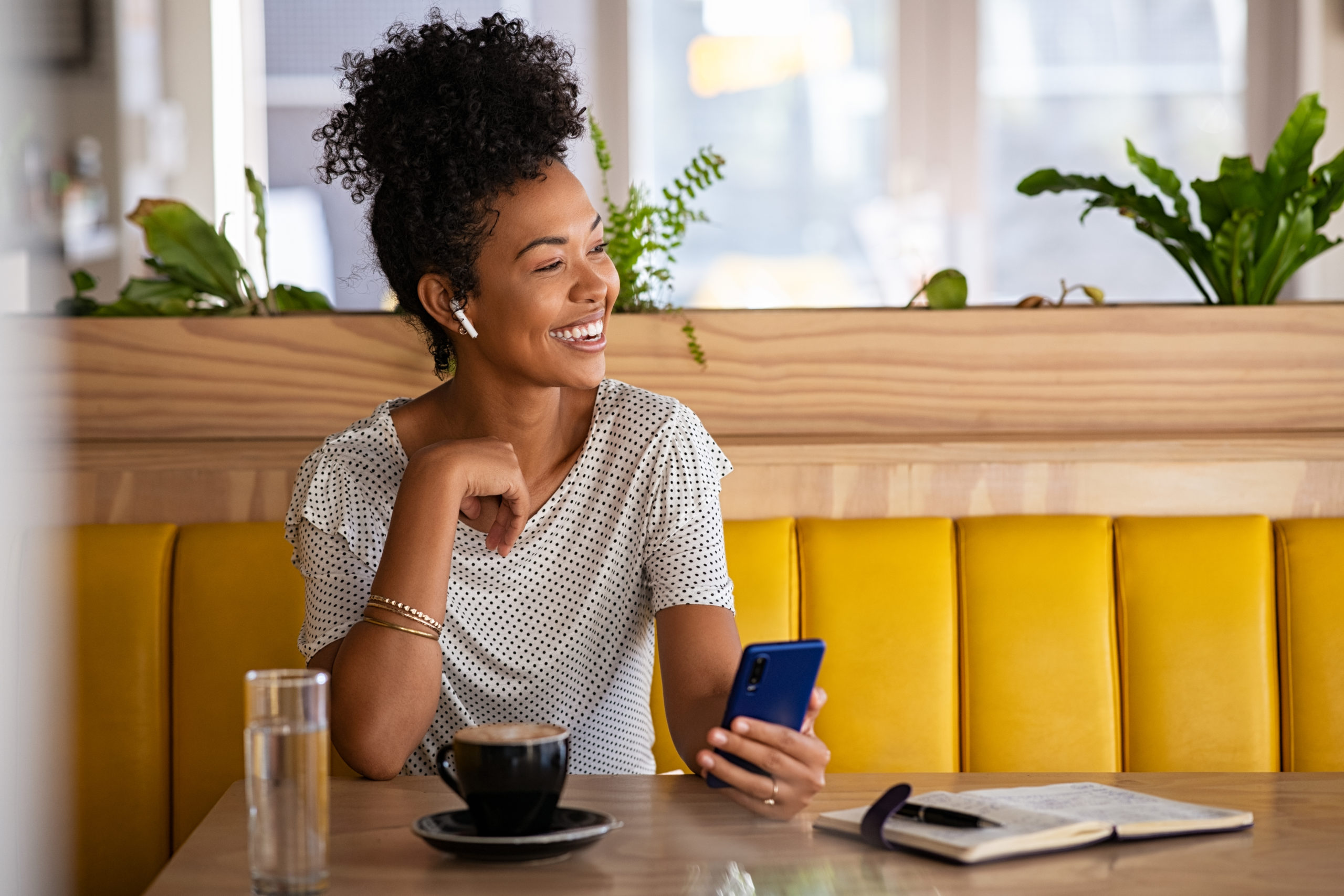 woman on the phone sitting at a cafe