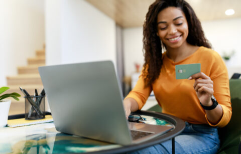 happy woman holding credit card