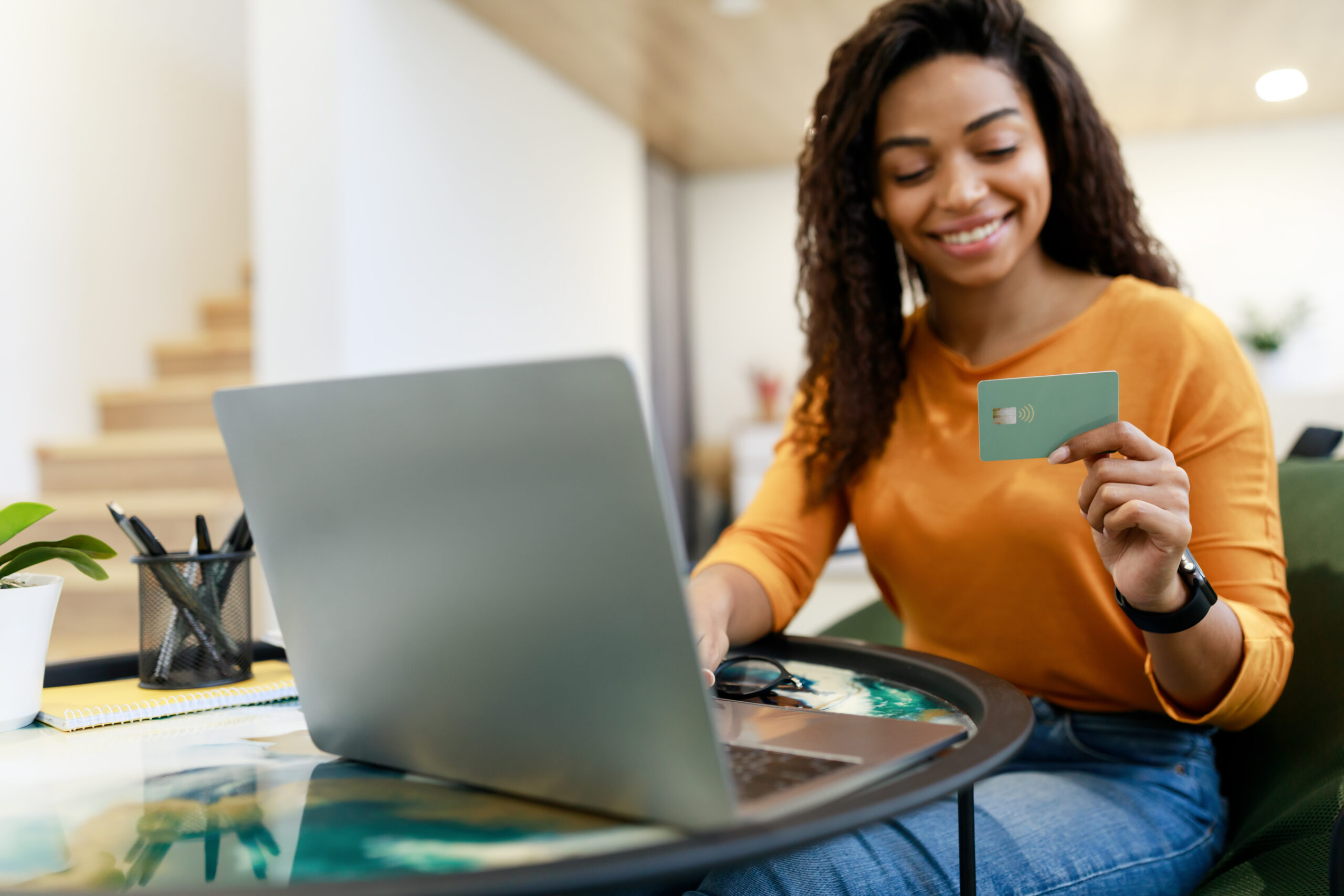 happy woman holding credit card