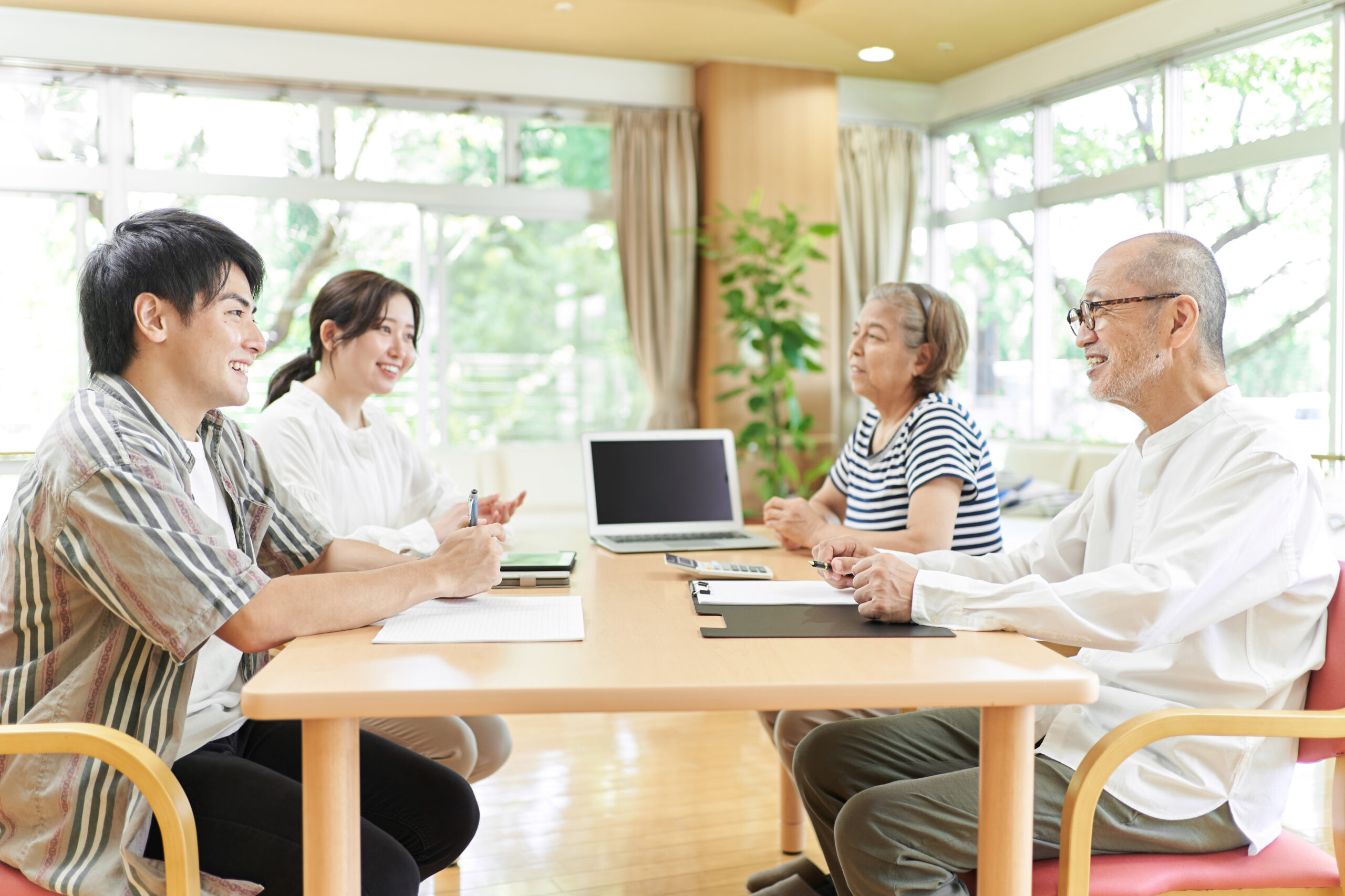 Young couple speaking to retired parents about reverse mortgages