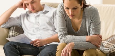 Worried couple discussing joint credit card