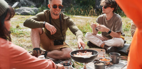 a group of people cooking while on summer vacation