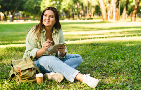 Student doing homework, e learning, preparing for test exam writing poems on college university park