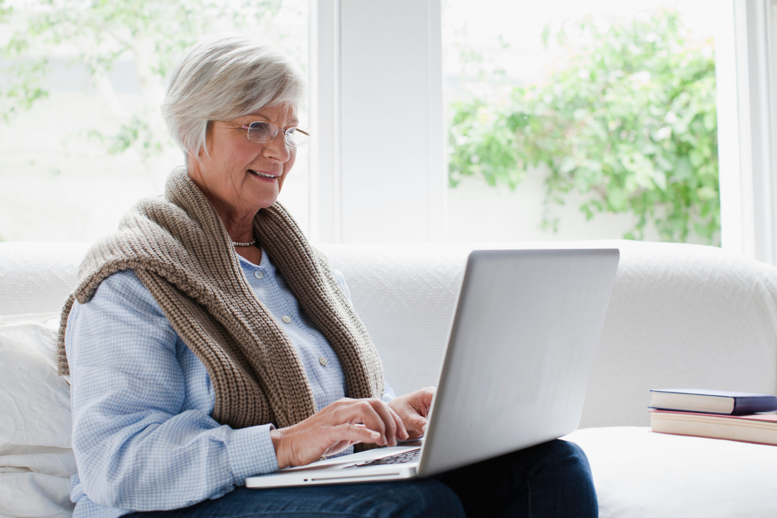 Smiling older woman using laptop