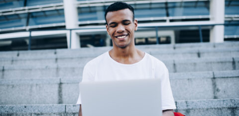 guy with laptop sitting on steps