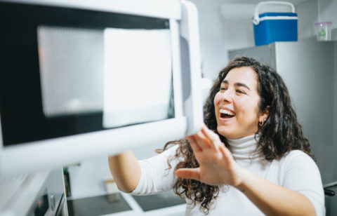 young woman making a microwave mug meal