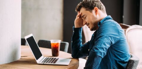 distressed man looking at computer