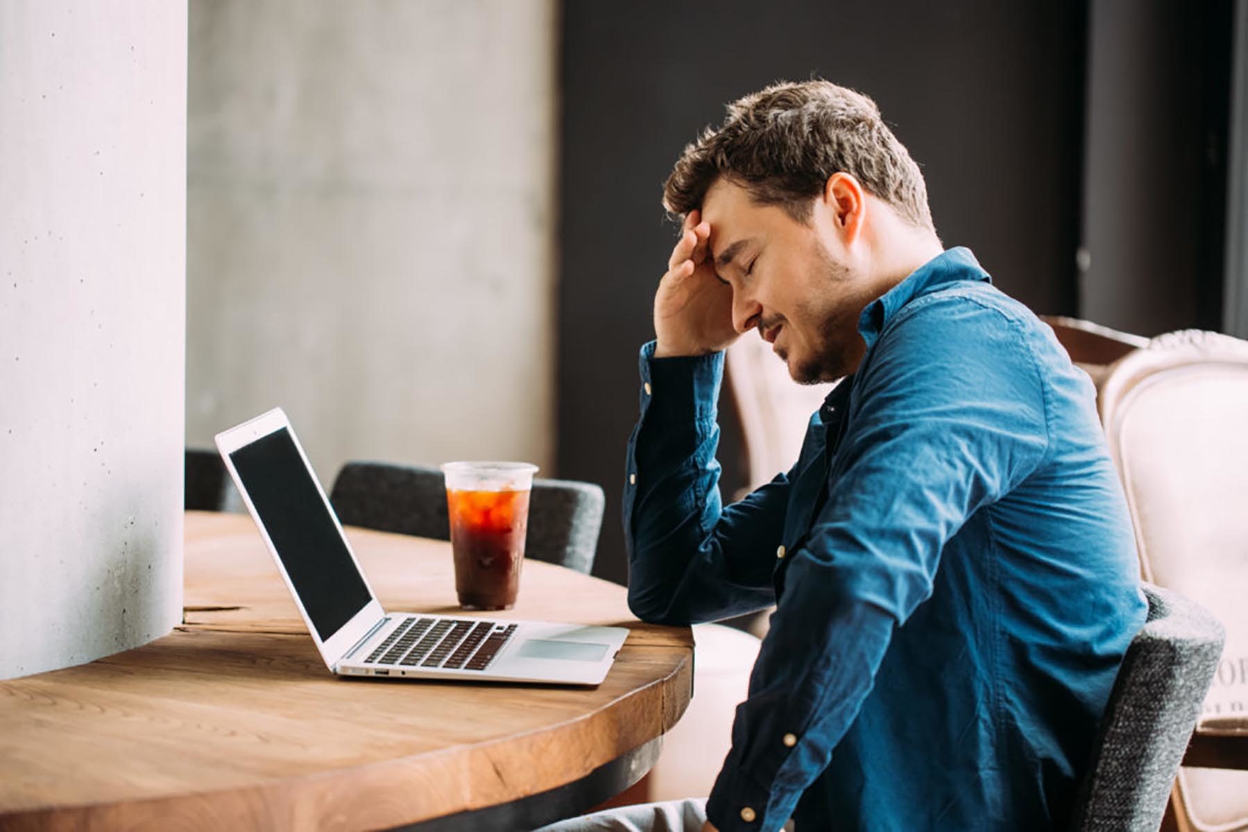 distressed man looking at computer