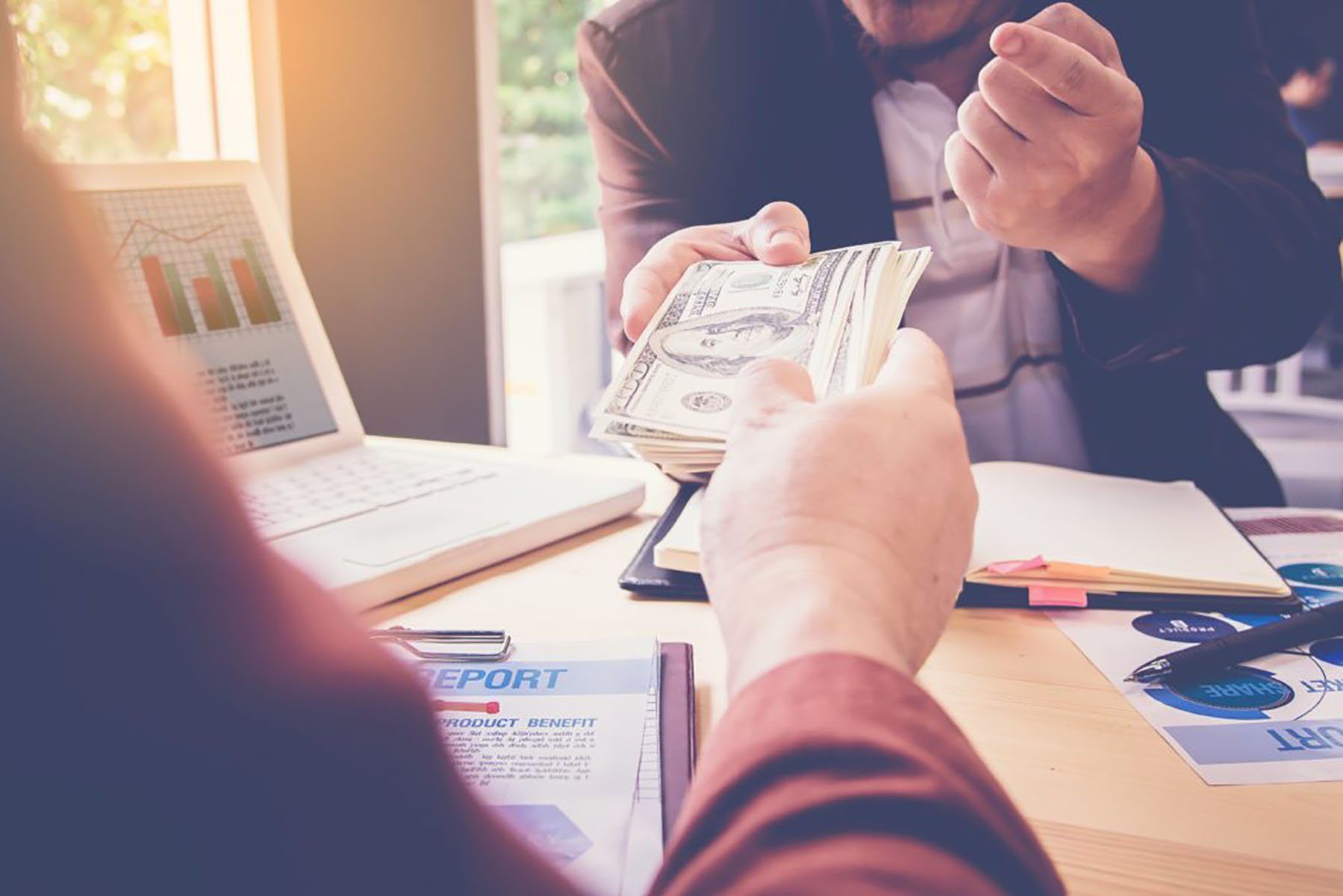 person handing over cash