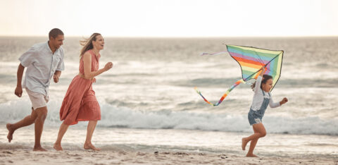 family on the beach enjoying a summer mini vacation