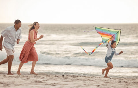 family on the beach enjoying a summer mini vacation