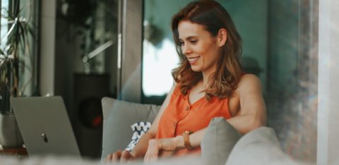 woman smiling at laptop