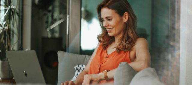 woman smiling at laptop