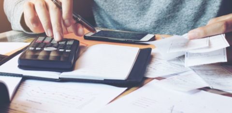 Man using calculator to calculate interest rates