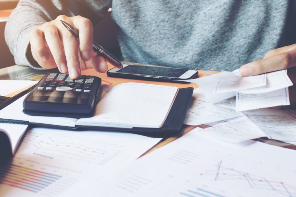 Man using calculator to calculate interest rates