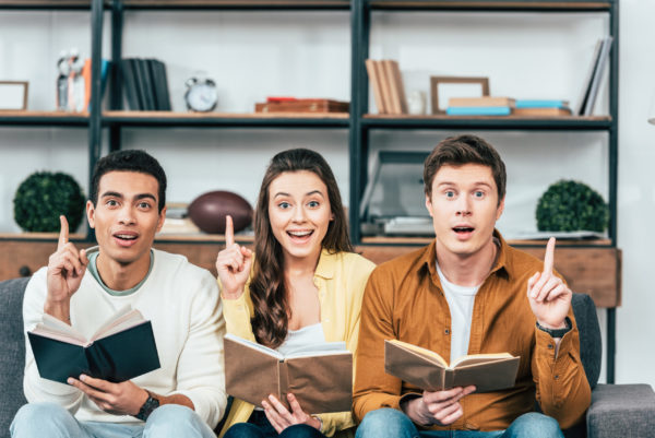 3 people reading books about money management