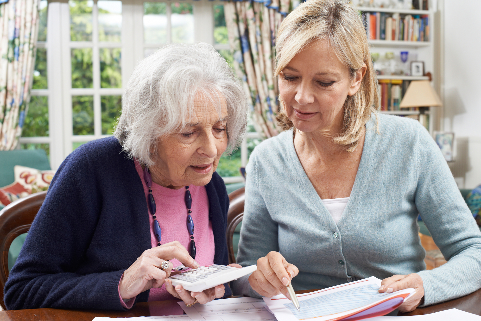 two women working to reduce credit card debt