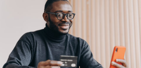 man on laptop researching credit cards