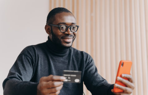 man on laptop researching credit cards