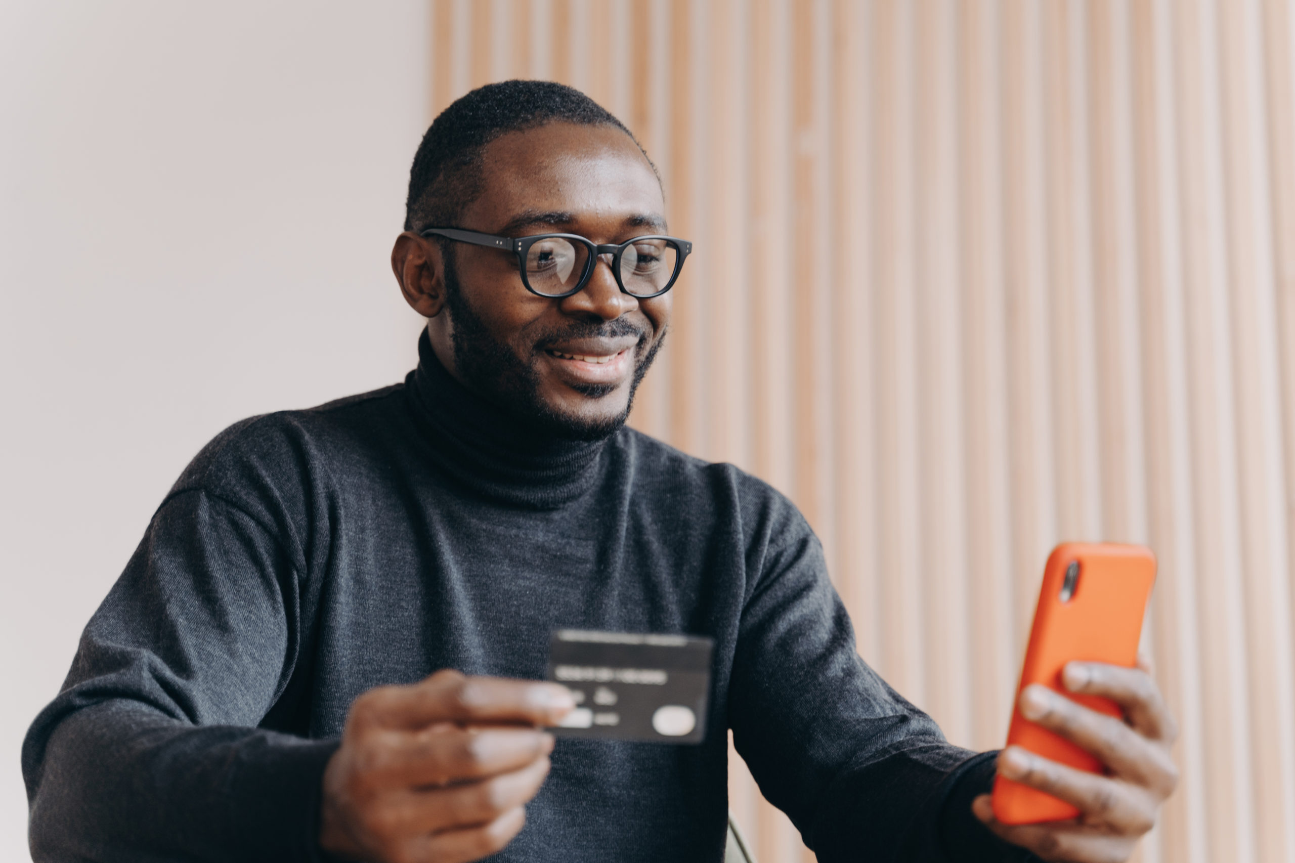 man on laptop researching credit cards