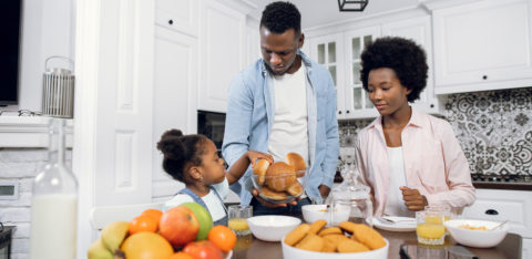 parents with their daughter in the kitchen