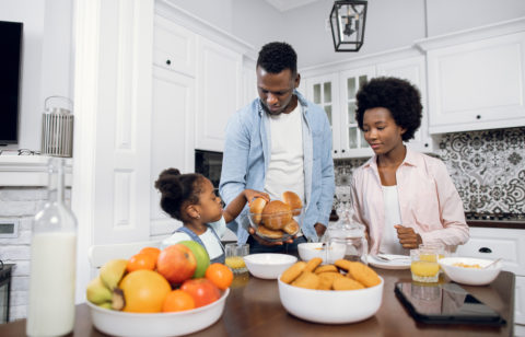 parents with their daughter in the kitchen