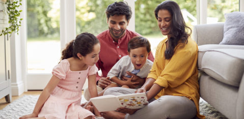 low income family sitting on the living room floor