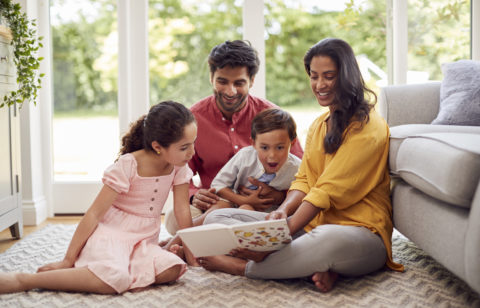 low income family sitting on the living room floor