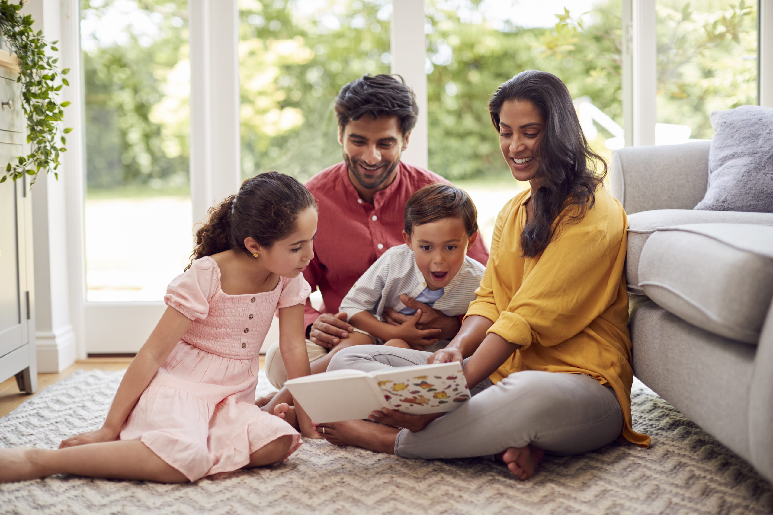 low income family sitting on the living room floor