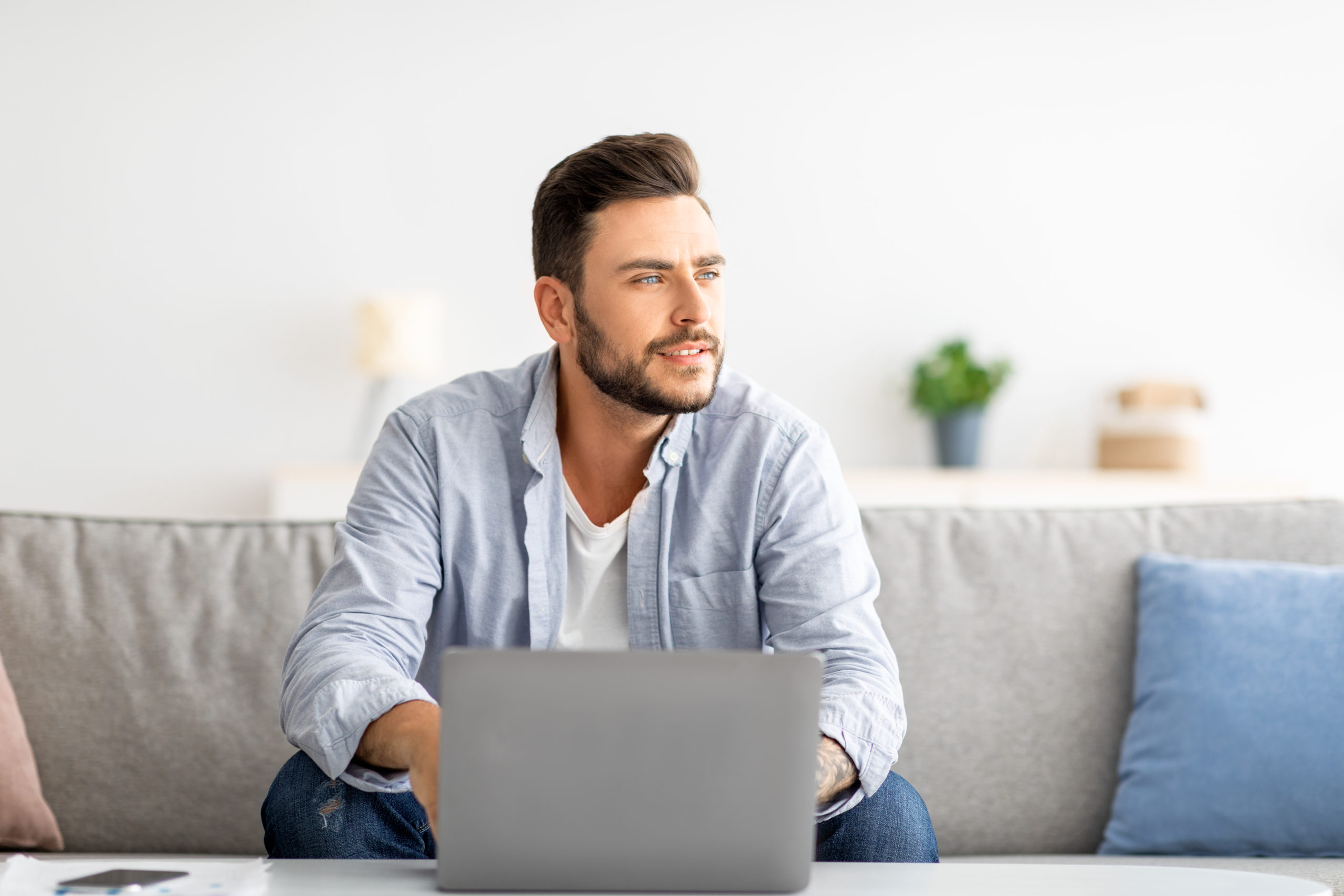 man thinking about paying off old debt