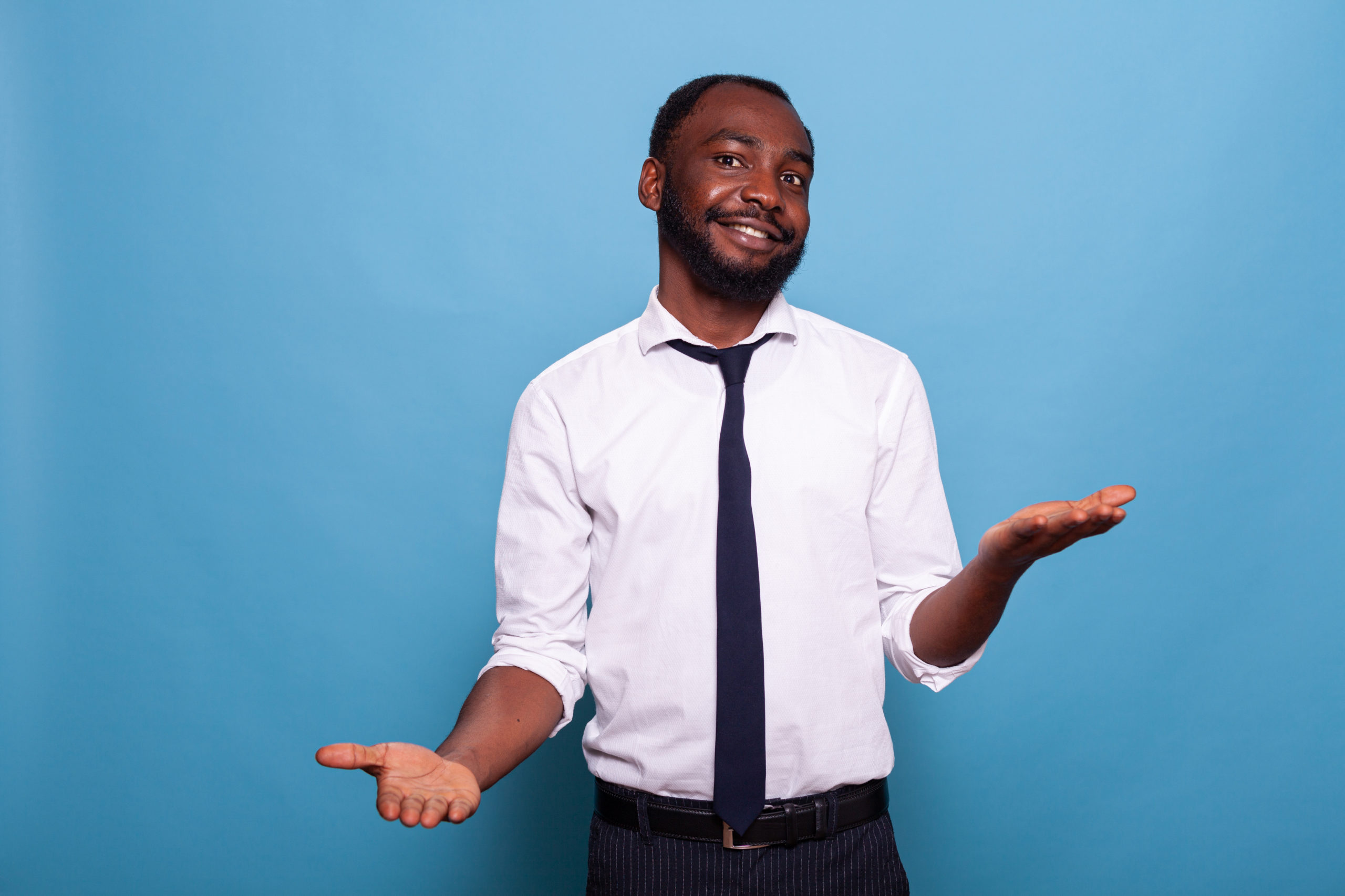 smiling businessman with open palms comparing pros and cons of debt consolidation