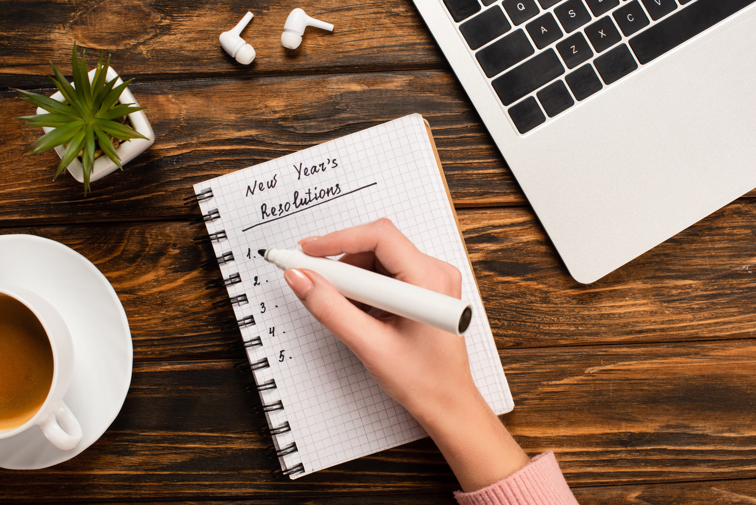 woman writing down financial new year's resolutions