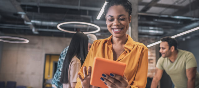 smiling african american girl with tablet