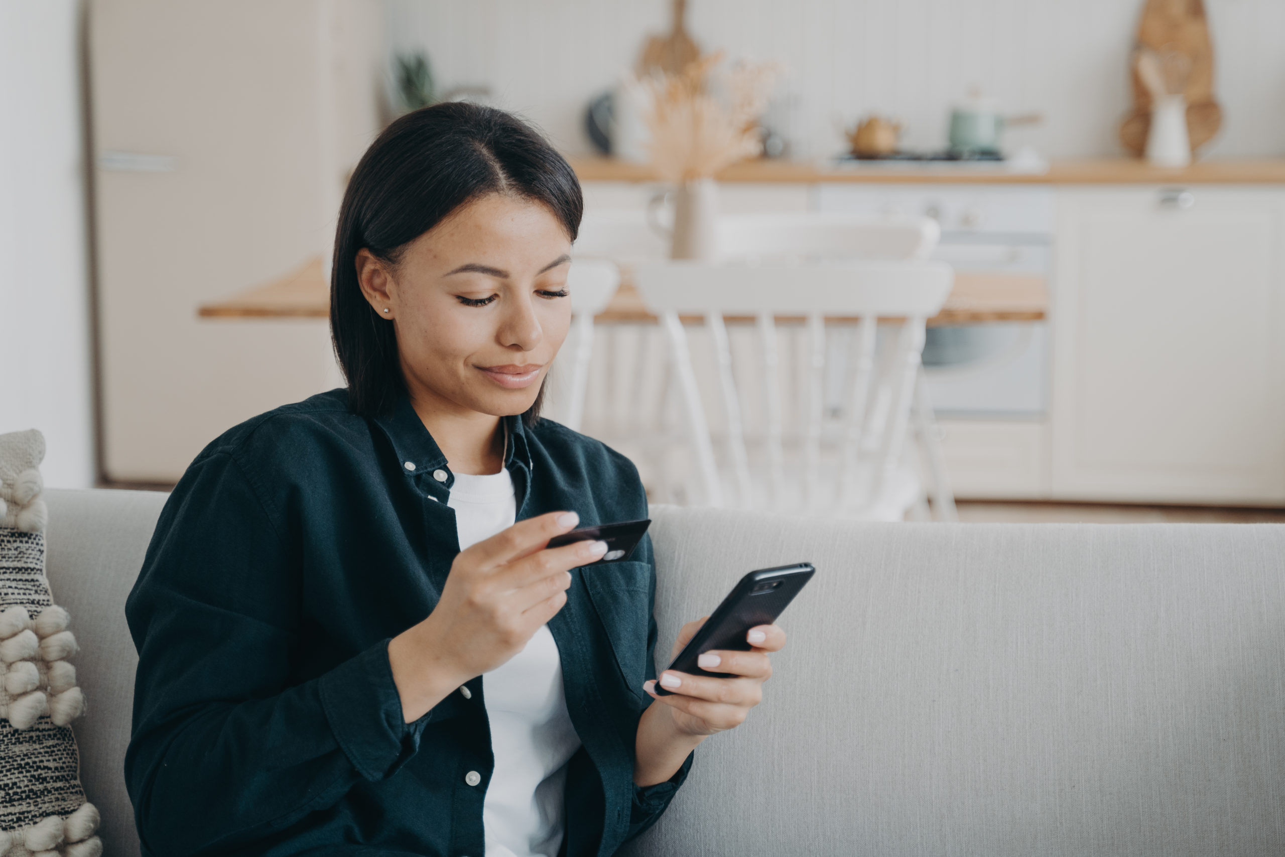 smiling woman calculating debt-to-credit ratio